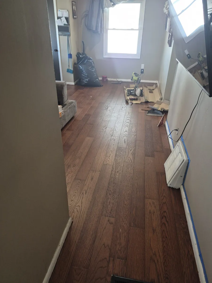 Hardwood floor installation underway in a hallway